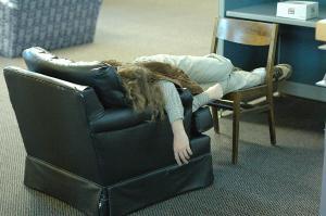 A student takes advantage of one of the leather couches on the librarys fifth floor to sleep.