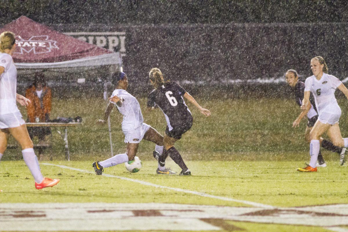 MSU senior defender Morganne Grimes (right) fights for a loose ball in the Bulldogs SEC opener against Missouri. The Dogs feel 3-1 in the rain-soaked match.