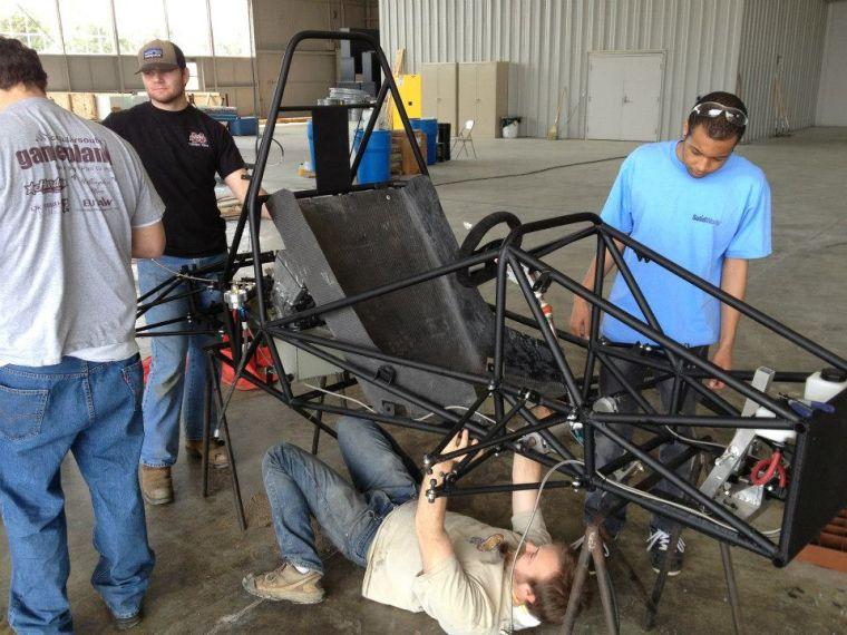 Two members of the FSAE work on constructing the body a racecar that placed 34th out of 120 teams in May.