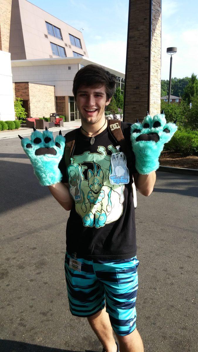 Brandon Stuart (pictured) shares his fox fursona with everyone by wearing his paws.