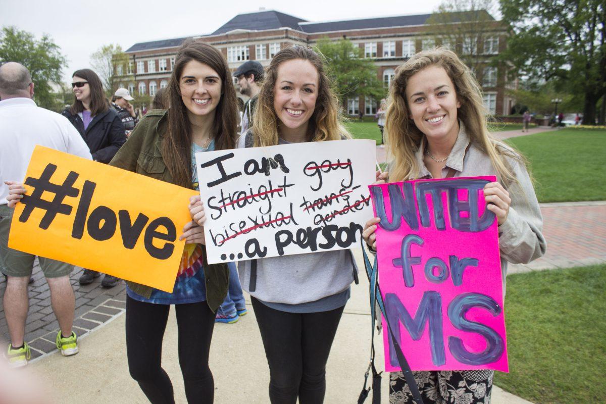 On Tuesday, April 12, Margaret Ann Horton, the organizer of the protest, carries signs along with Emily Dallas and Kaili Morgan, on the Drill Field to support their belief in regards to HB1523. 