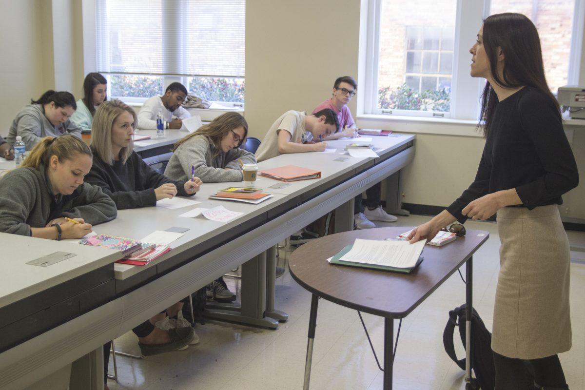 Catherine Pierce hands out graded papers to her students during her afternoon Creative Writing class in McCain Hall prior to beginning a quiz on their recent reading assignment.