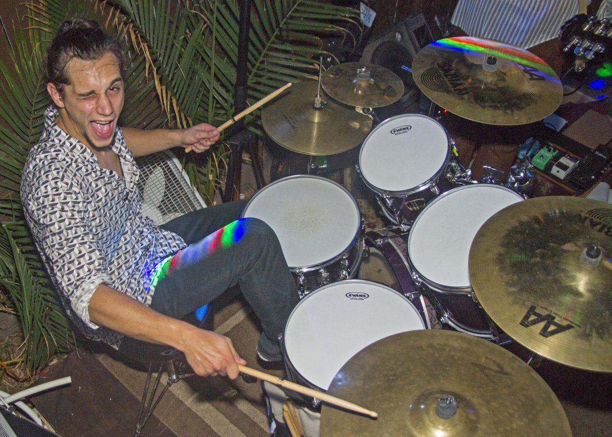 Vaughn Brenner winks for the camera as he smashes out a drum solo during the band’s performance at the Bin 612