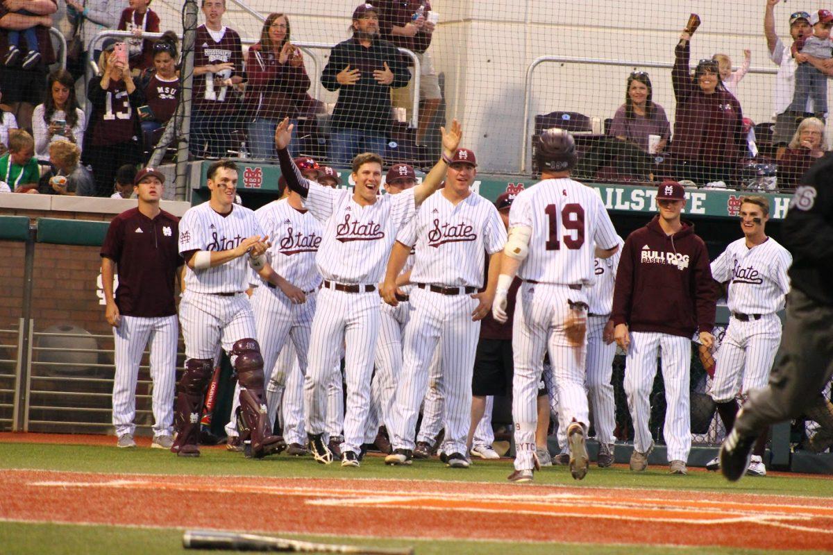 Rooker celebrates with his team. He hit three home runs and batted six runs in.