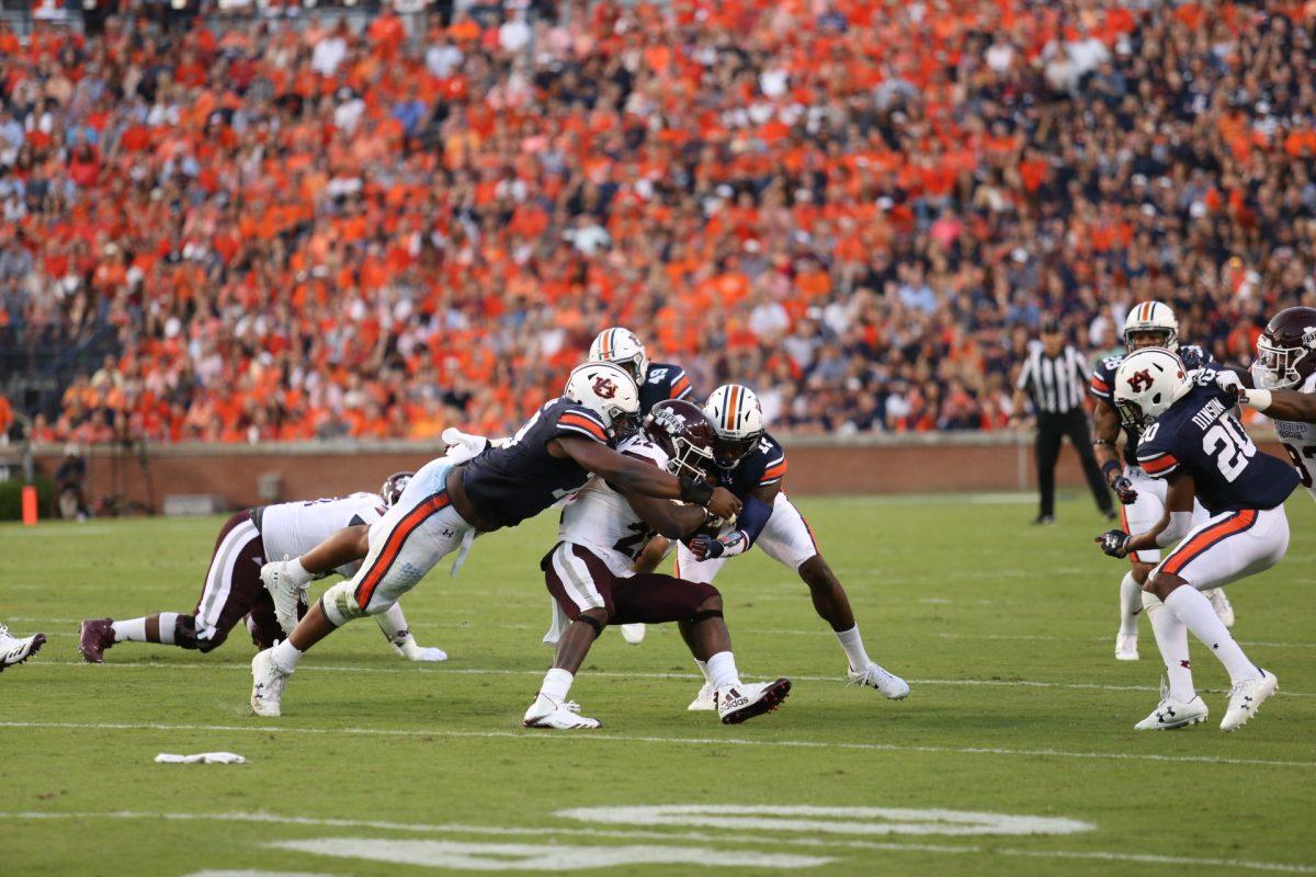 Running back Aeris Williams is tackled by multiple Auburn defenders. He gained 53 yards on 15 carries. 