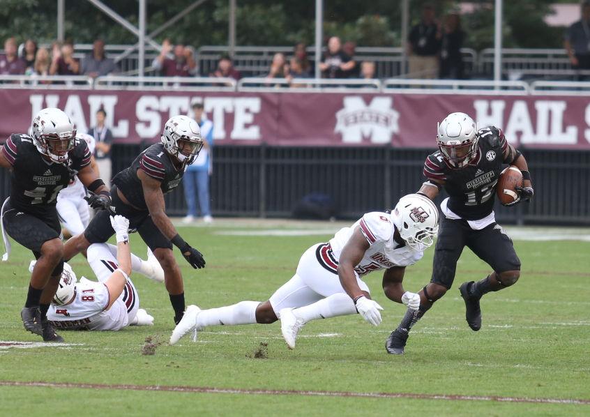 MSUs J.T. Gray, a junior linebacker from Clarksdale, stiff arms a UMass player on his way to a 58-yard interception return for a touchdown. 