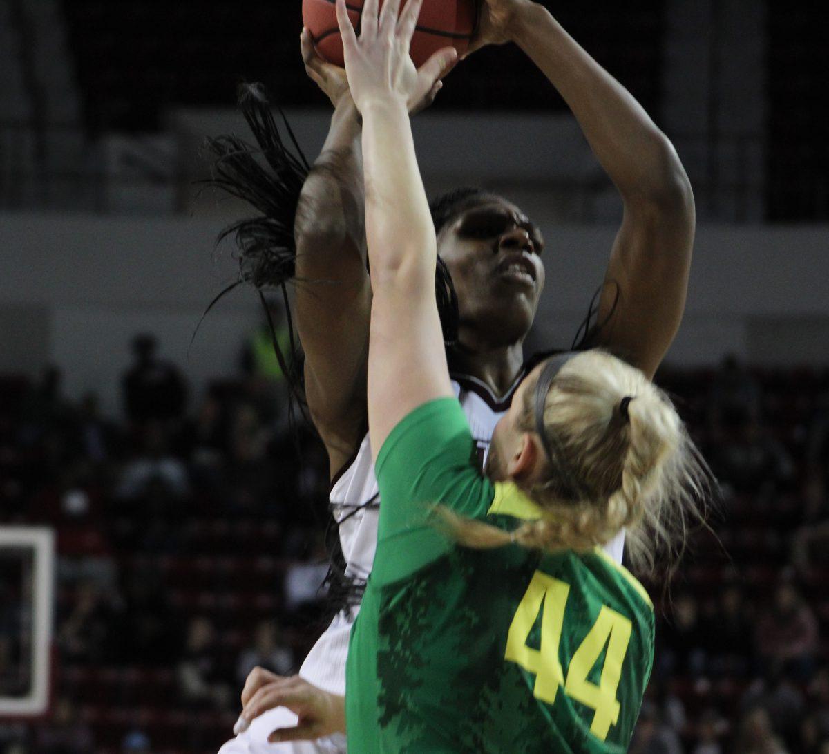 Tearia McCowan overpowers an Oregon defender on her way to a lay-up. She scored 35 points in Mississippi State Universitys 90-79 victory over the No. 9 University of Oregon Ducks.
