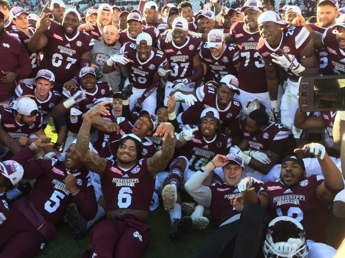 Mississippi State Universitys football team gathers together after their TaxSlayer Bowl win to take a celebratory photo. 