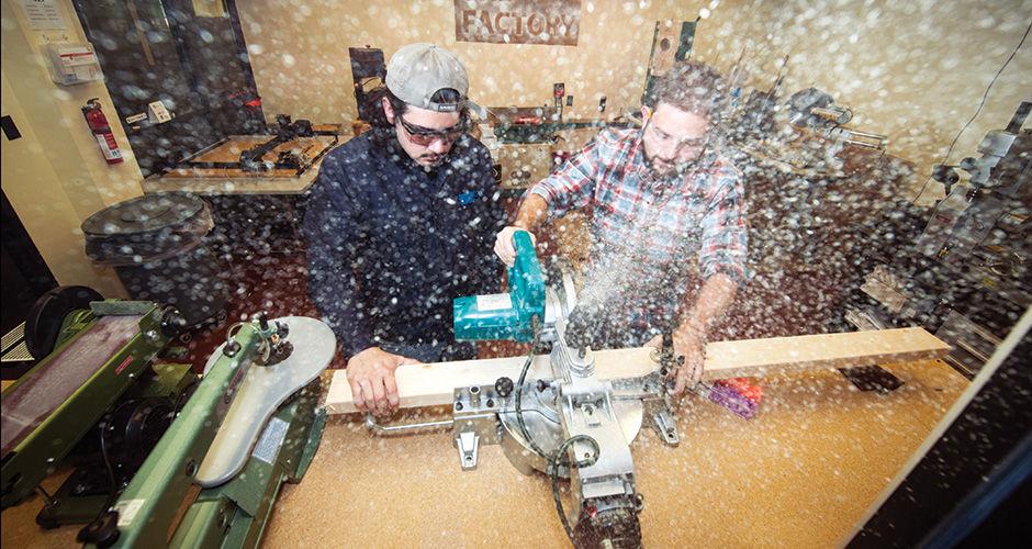 Nico Ramirez, left, and Michael Lane use woodworking tools at the new makerspace.