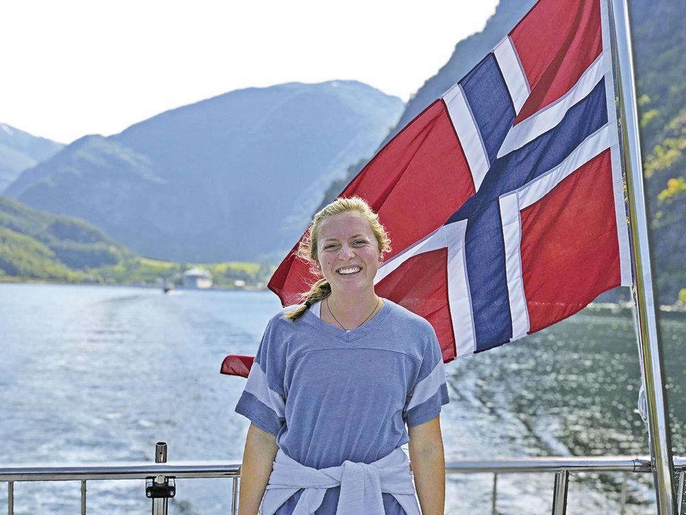 Junior Kendra Sanders smiles while she is on a fjord tour in Norway as the countrys flag waves behind her. Sanders spent last summer in Iceland and Scandinavia.
