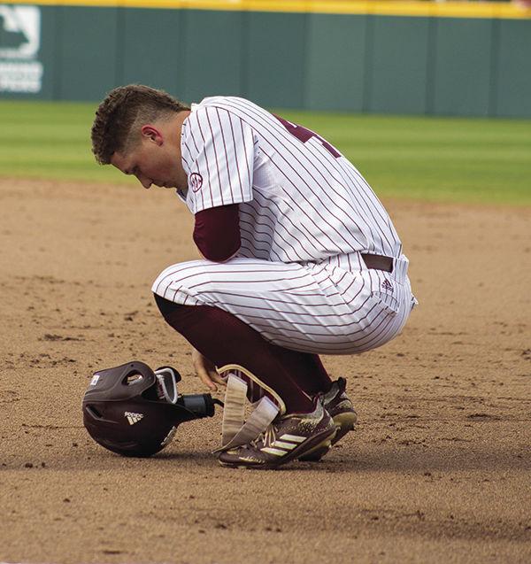 Elijah+MacNamee+looks+down+at+the+ground+in+front+of+first+base.+MSU+has+lost+every+series+to+LSU+that+they+played+at+home+since+2003.