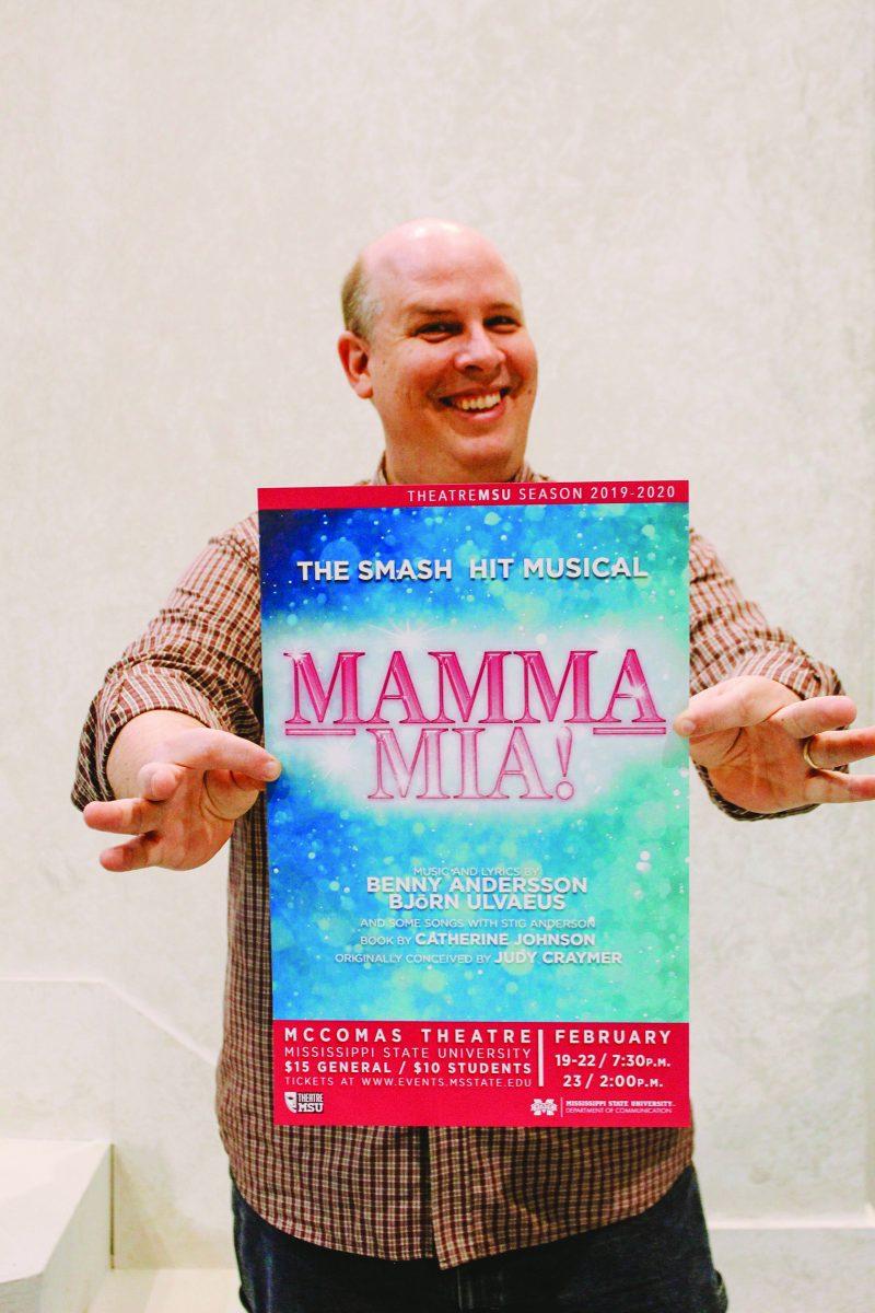 Tim+Matheny%2C+assistant+professor+of+theatre+and+a+director+of+Theatre+MSU%2C+holds+a+poster+for+his+last+production+at+MSU%2C+%26%238220%3BMamma+Mia%21%26%238221%3B