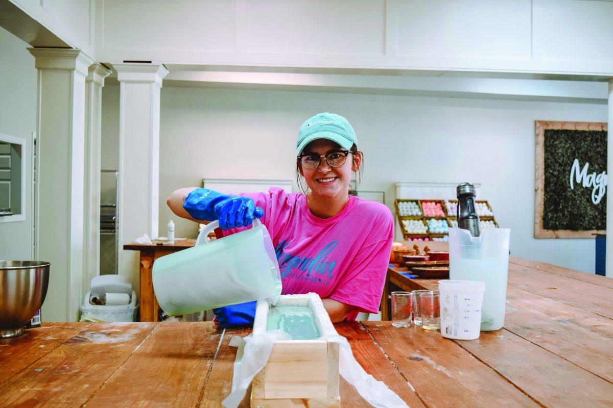 Patience Mcree, part-owner and general manager of Magnolia Soap and Bath Company, pours soap.