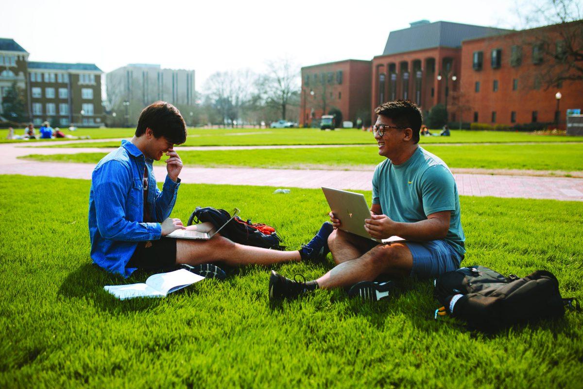 Daniel Dye and Jason Hwang sit on the Drill Field on Monday. Although COVID-19 regulations were in place this semester, MSU plans on mostly in-person classes in the fall.