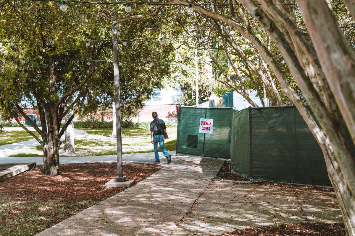 The sidewalk on the north side of the Mitchell Memorial Library has been temporarily closed due to the maintenance and replacement of old air conditioning units.