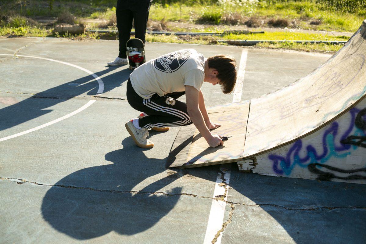 A student screws a skateboard ramp back together at Moncrief Park. The new funding will improve existing park features and expand park maintenance. 