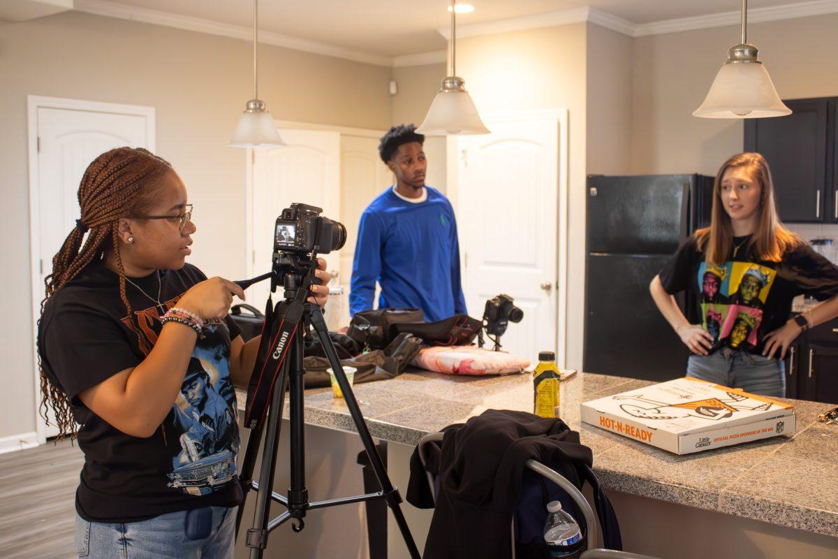 Teirrah Tidwell, Anothony Jenkins, and Lolly Beck film scenes from multiple angles for their short film.