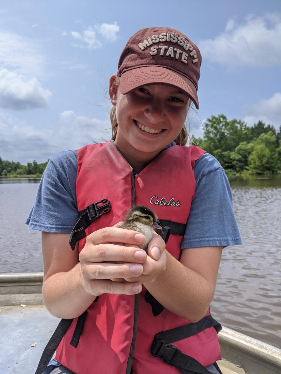 MSU student Mattie Graham with a day-old wood duck.