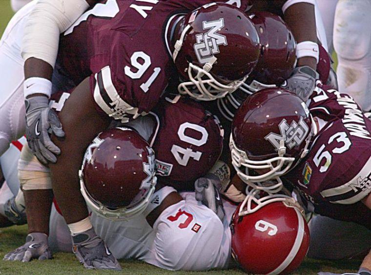 A sea of maroon jerseys smashes into a JSU player in Saturday evenings victory.