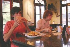 Corey Bishop, left, a senior majoring in business information systems, along with Josh Doty, a senior majoring in English, enjoy burgers at Rock Bottom Bar and Grill in the Cotton District.