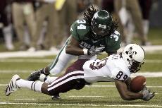 Defensive back Derek Pegues fights Tulane safety Devin Holland for the ball in the third quarter of Saturdays game.