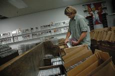 Senior business administration major and Bebop Records employee Jason McCain restocks the stores shelves for the stores closing sale. Bebop, which has been a local favorite for more than 25 years, will close its doors permanently on Saturday.