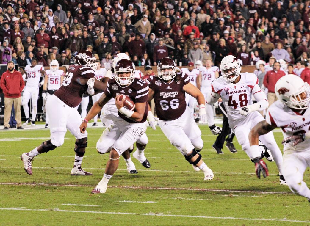 Dak Prescott runs the football against the Razorback defense in Saturday night’s game. Prescott is tied second with Arkansas running back Jonathan Williams in the SEC for rushing touchdowns.
 