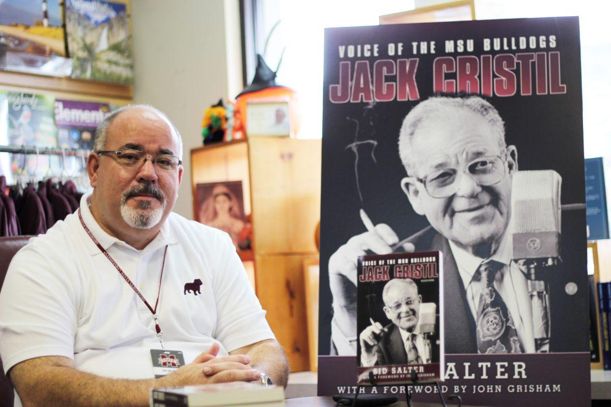 Sid Salter sits and signs copies of the re-release of his book, Jack Cristil - Voice of the MSU Bulldogs.
