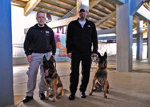 Mississippi State University Police Officers stand under the Davis Wade Stadium with their K-9 partners. MSU Police Department currently has three K-9 units, all Belgian Malinois. 