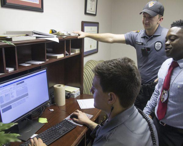 Corporal Emmitt Johnson (middle) comments on the review he is having with officer Alec Vaughn( furthest) and officer Julien Gillis (closest) in the interview room as they prepare for the Law Enforcement Assessment nearing in February.
 
