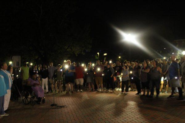 The crowd joined hands in prayer and song at the end of the vigil to show the unity of community. 