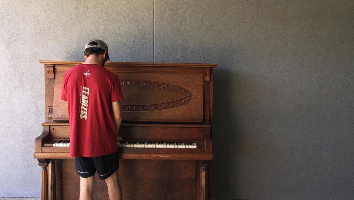 Kyle Schumpert, an MSU alum, takes advantage of one of Starkville’s new street pianos.
