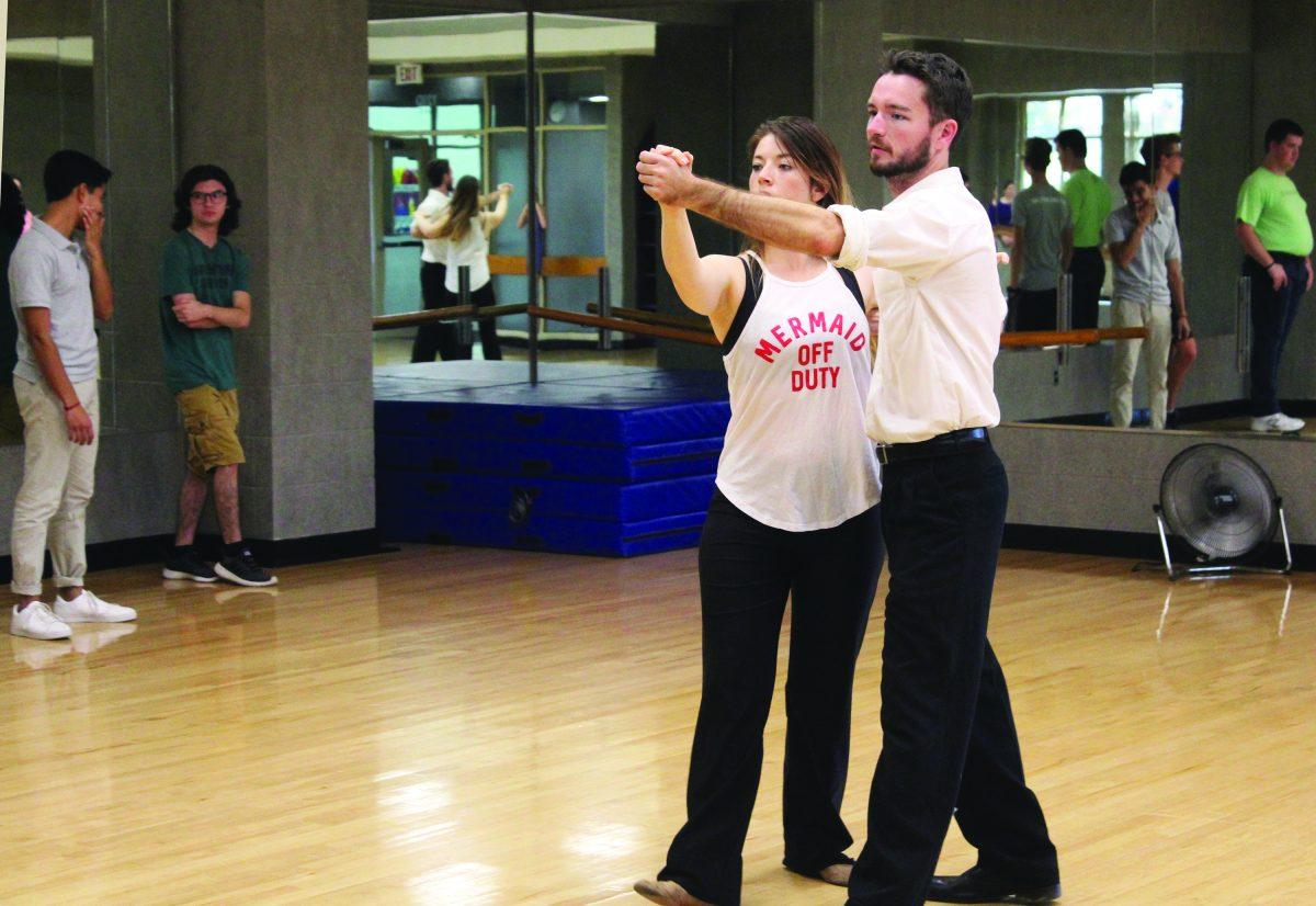 Graduate student Matt Cagle and senior Siobhan Grogan teach a group of dancers the basic steps of smooth dance.