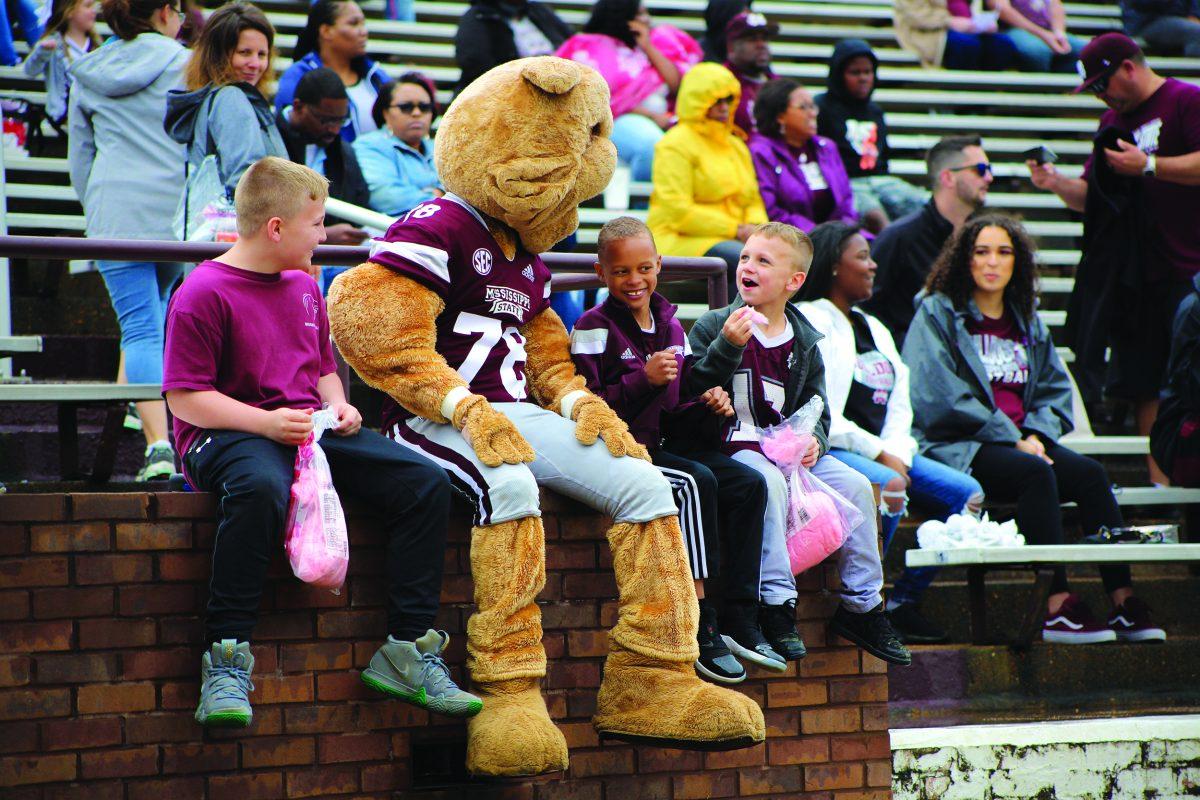 Children+eat+cotton+candy+and+talk+with+the+MSU+mascot+at+the+Super+Bulldog+Weekend+football+game.