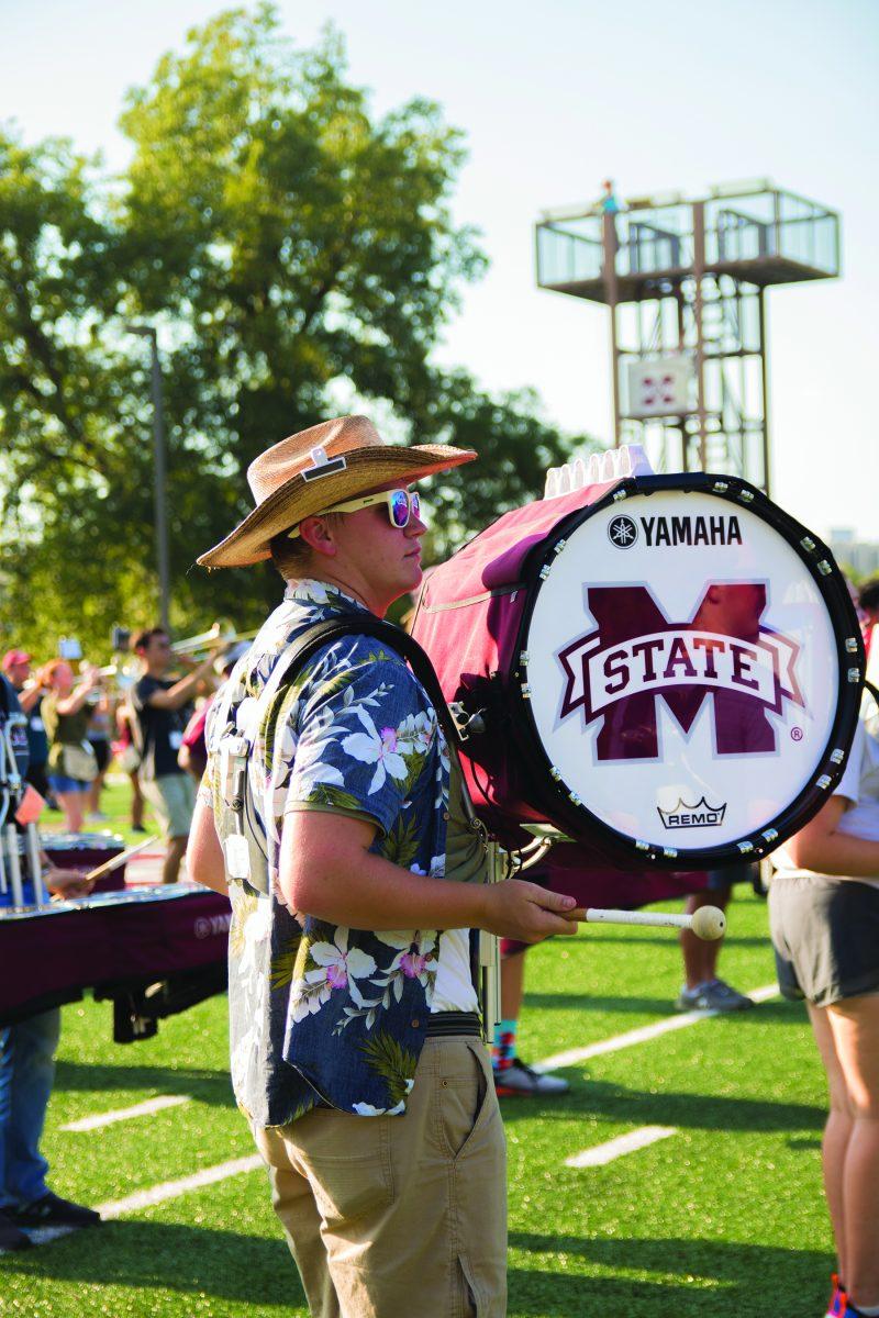 Senior band member Jonathan Hall plays the drum during Tuesday’s marching band practice in preparation for the first home game on Saturday.