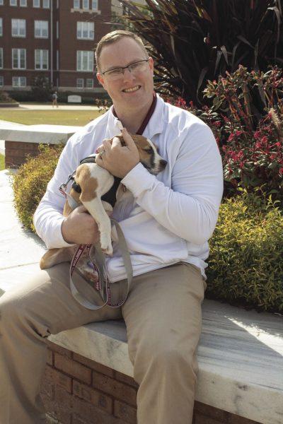 Riley McCormick enjoys the Drill Field on Monday afternoon with his alert dog Rocky that he got through the Bully’s Battle Buddies program at Mississippi State University.