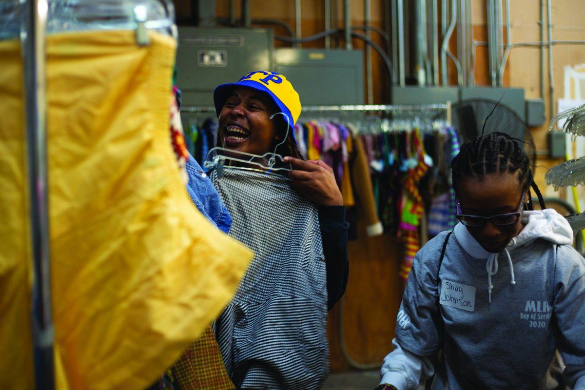 Asia Harris and Shay Johnson hang clothes at the Palmer Home Thrift Store during the Martin Luther King Jr. Day of Service on Monday. Volunteers went to 22 sites around Starkville. 
