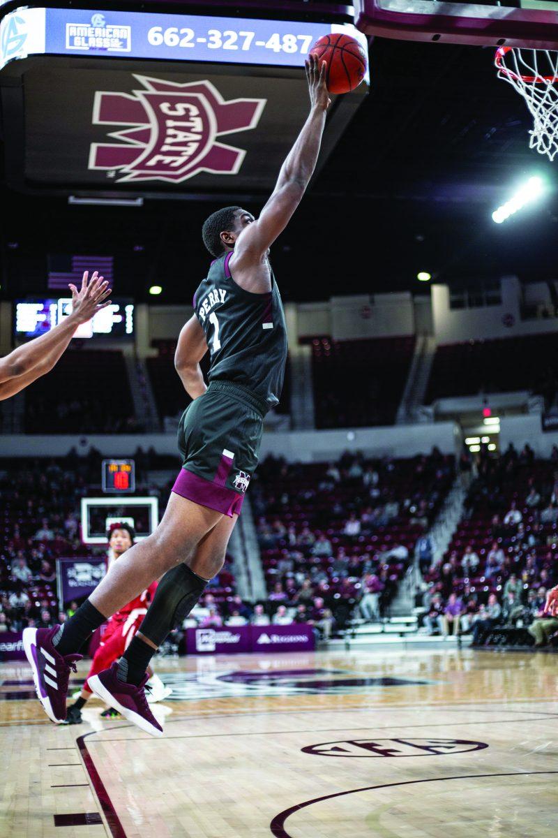 Reggie Perry leaps to dunk the ball against Arkansas. Perry had 26 points in the game.