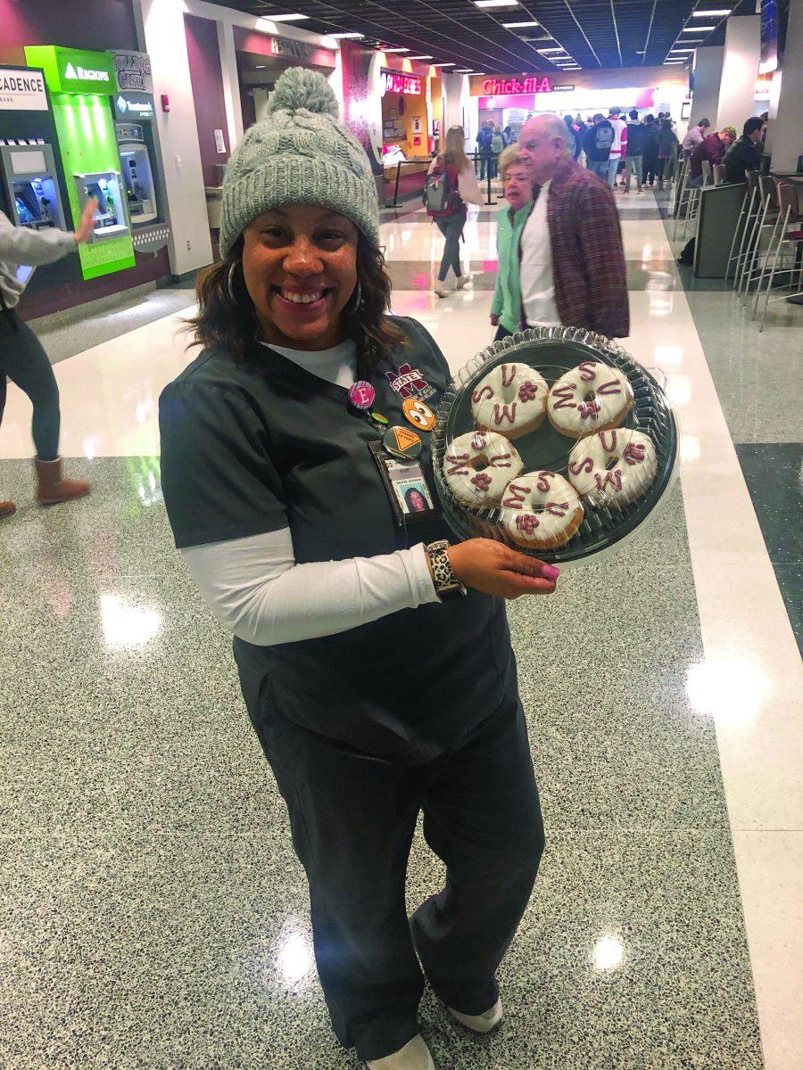 Santee Ezell-Johnson, assistant director of Health Promotion and Wellness, poses with donuts.donuts.
