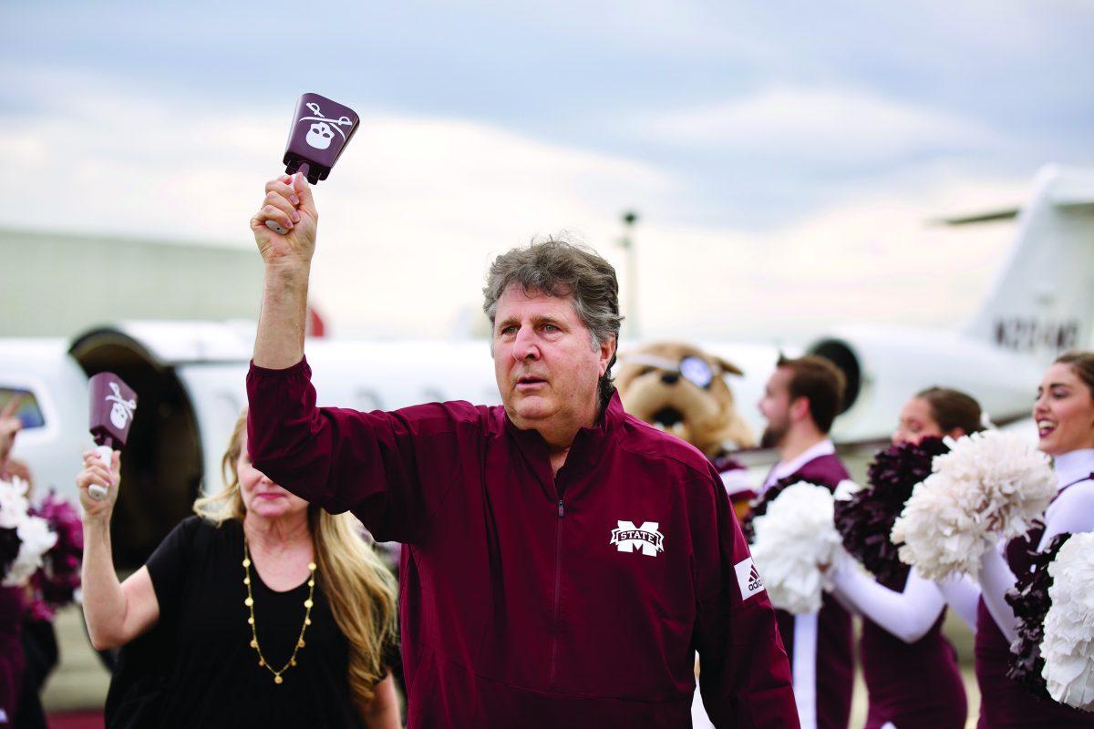 Head+coach+Mike+Leach+rings+a+Jolly+Roger+cowbell+on+his+arrival+in+Starkville+Friday+afternoon.