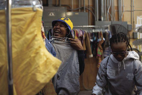 Asia Harris and Shay Johnson hang clothes at the Palmer Home Thrift Store during the Martin Luther King Jr. Day of Service on Monday. Volunteers went to 22 sites around Starkville.
 