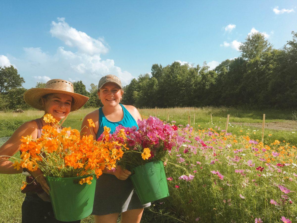 Eryn Sanders, a senior kinesiology major, is pictured with her sister, Sarah Sanders, at the flower farm she worked at over the summer.