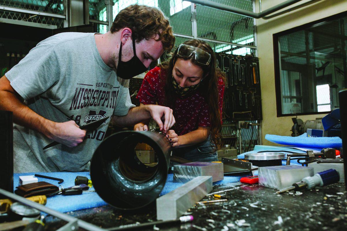 Space Cowboys Eric Malone and Grace Williams work on parts for their competition rocket, the Astraea, in Patterson Engineering Laboratories.