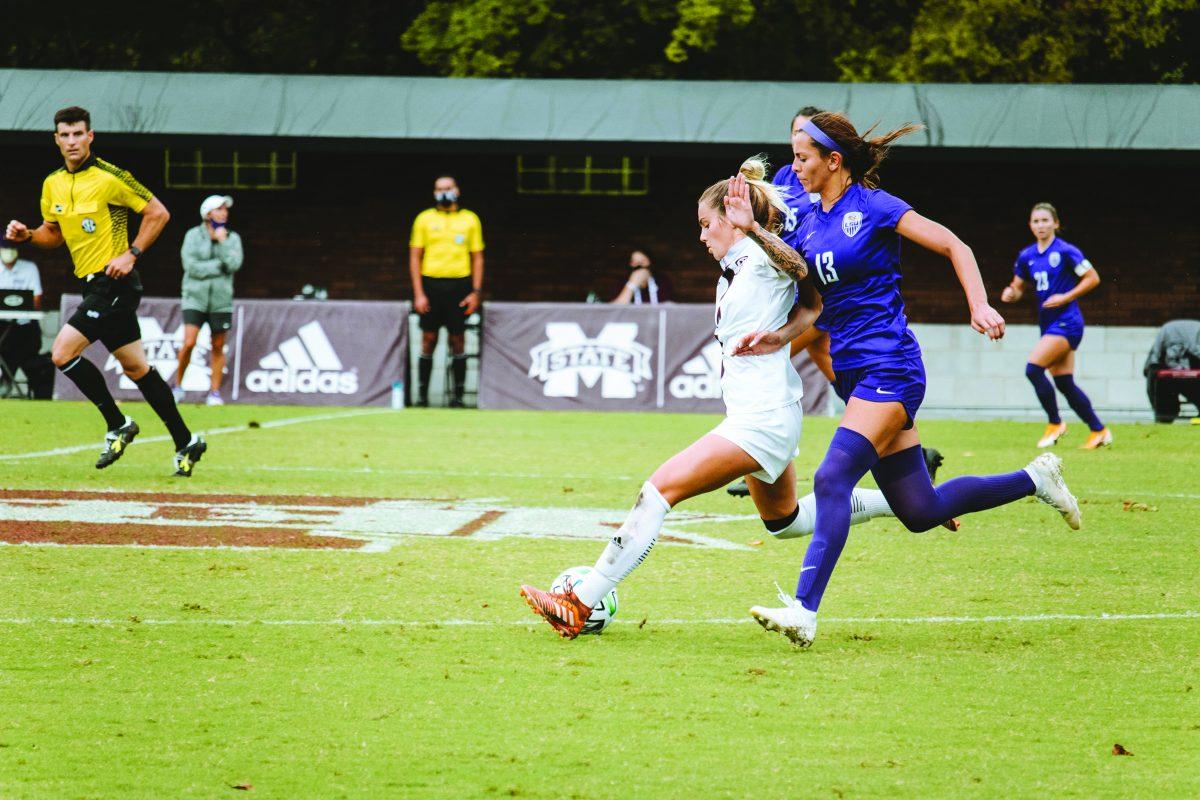 Redshirt freshman midfielder Macey Hodge from Douglasville, Georgia keeps the ball in possession despite defense from Louisiana State University’s freshman forward Taylor Dobles during Sunday’s game where the Bulldogs pulled out a 2-1 victory against the Tigers.
