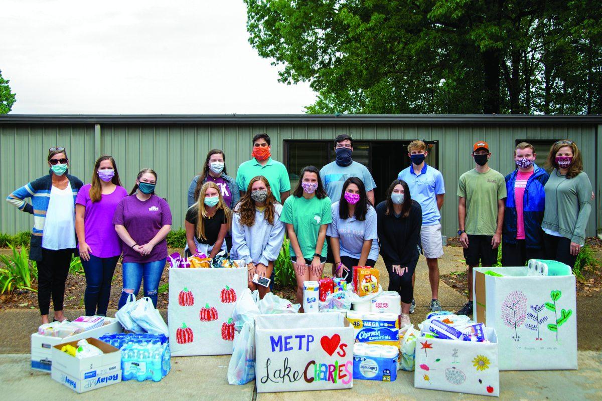 METP students pose with the goods they collected to send to the Lake Charles, Louisiana, community after it was affected by recent hurricanes.