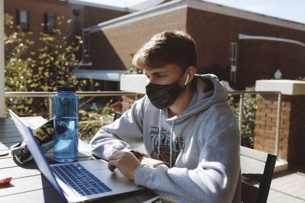 Clay Smith attends class via Webex at the Colvard Student Union while wearing a mask to help prevent the spread of COVID-19 on Mississippi State University’s campus.