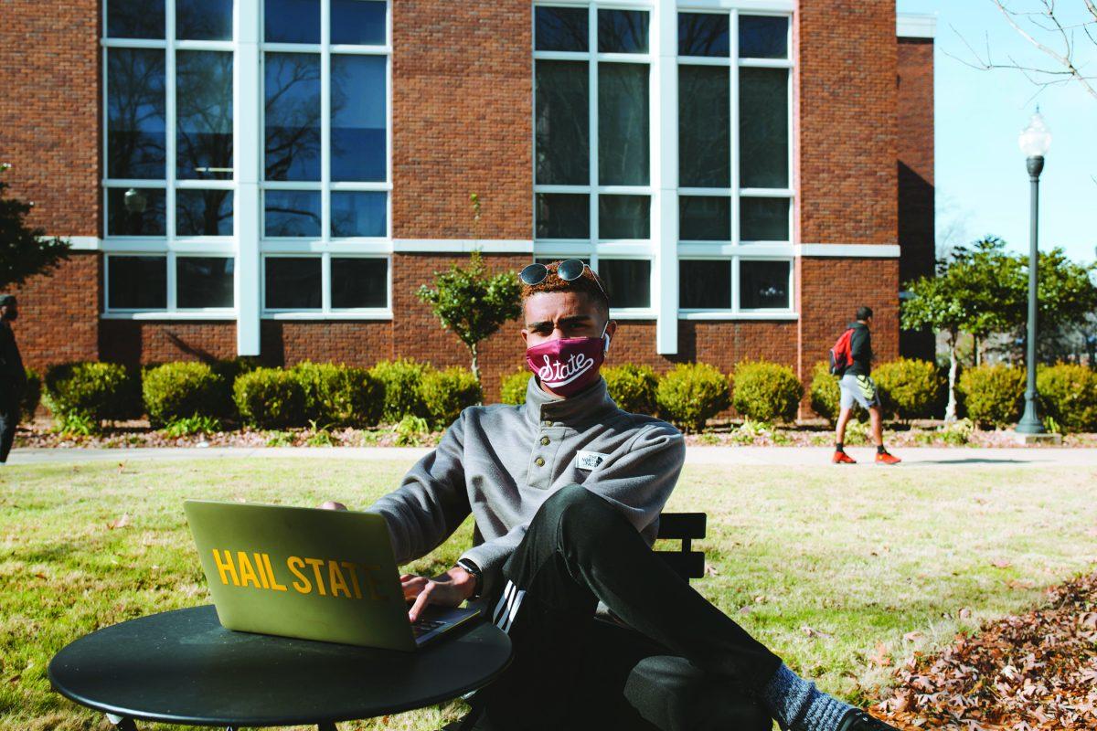 Tim Walker follows Cowbell Well guidelines by distancing and wearing a mask while outside of the Union on MSU’s campus.