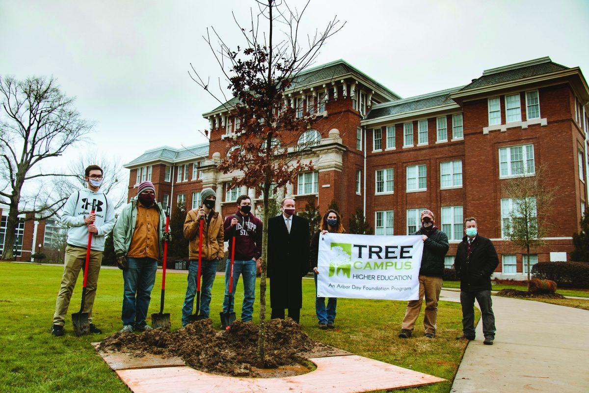 MSU President Mark Keemun, Wes Burger and scholarship recipients celebrate the planting a white oak tree on the Drill Field for Mississippi’s Arbor Day.