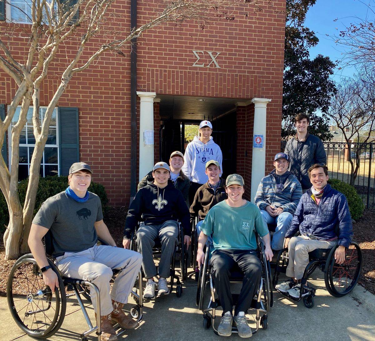 MSU student Thomas Guest poses with participants of the Come Roll with Me program held at the Sigma Chi house on February 2.