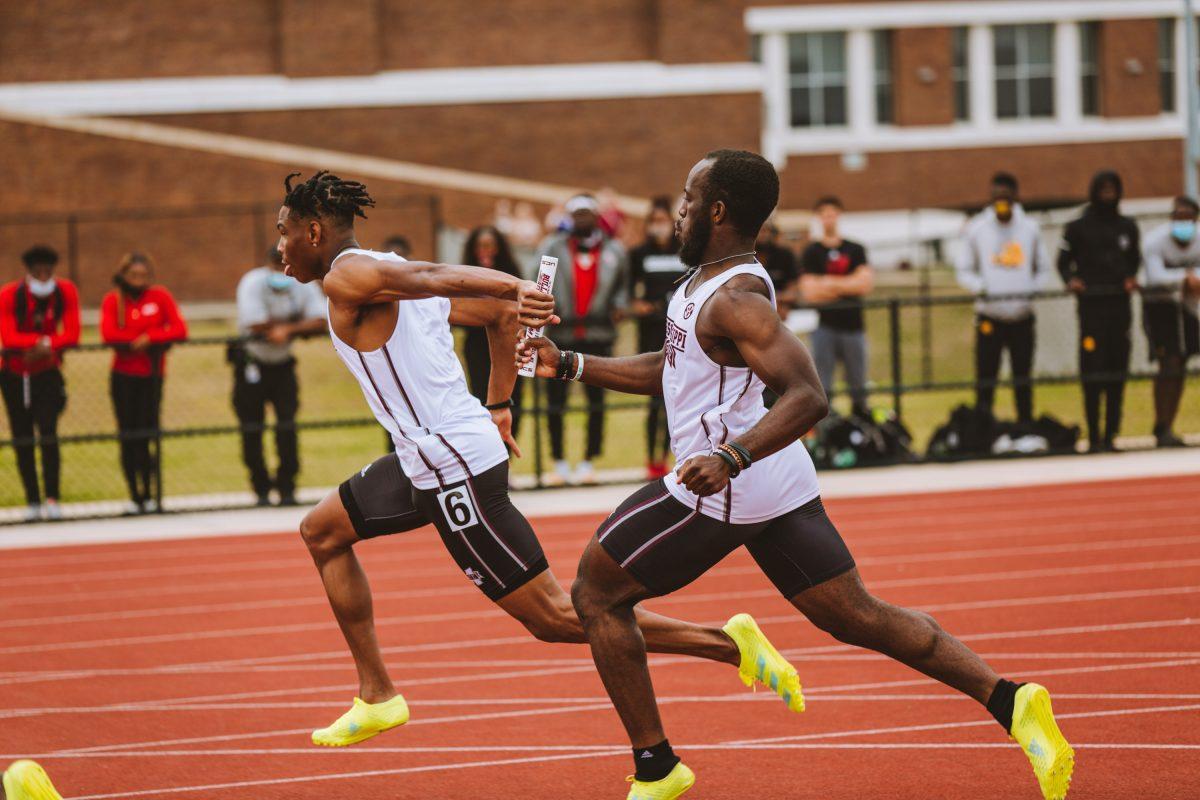 Cameron Crump (left) and Okheme Moore (right) handle a baton pass in this past weekend’s action during the men’s 4x100 meter relays, in which they placed first.